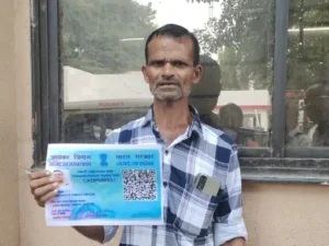 Person holding identification card outdoors.